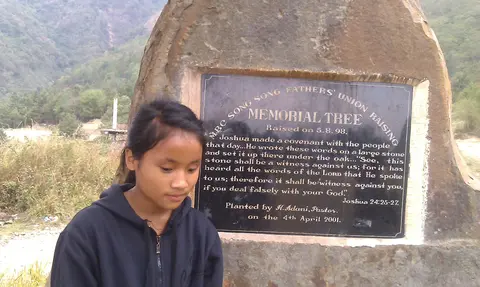 MS NZANO NEAR ONE OF THE  MONOLITH AT MAO