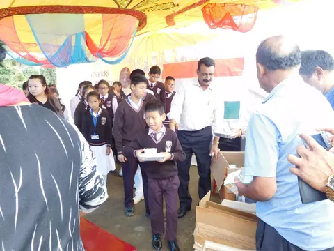 MEMBERS OF THE KERELA CLUB GIVING AWAY SNACKS AND STATIONARY ITEMS 